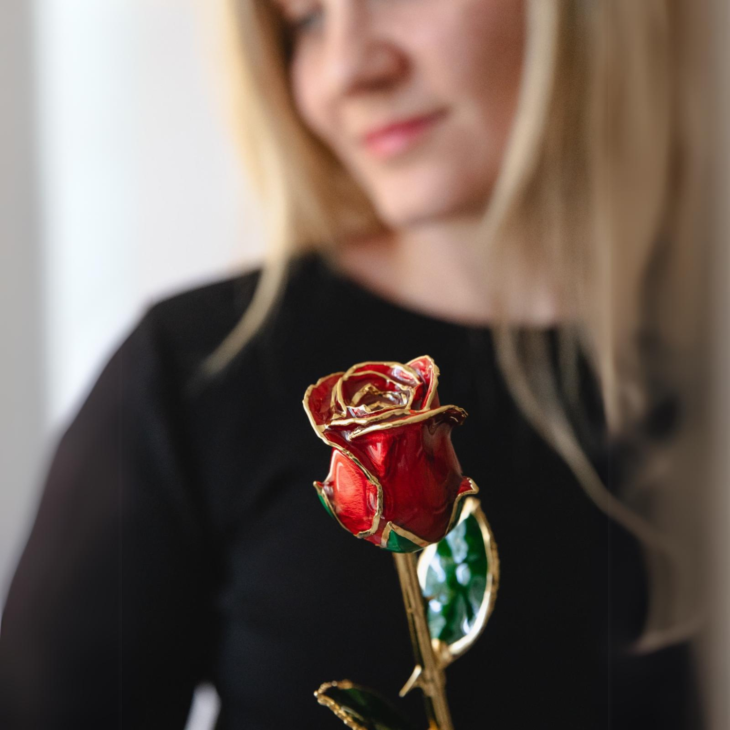 24k gold dipped rose red with woman holding it 2