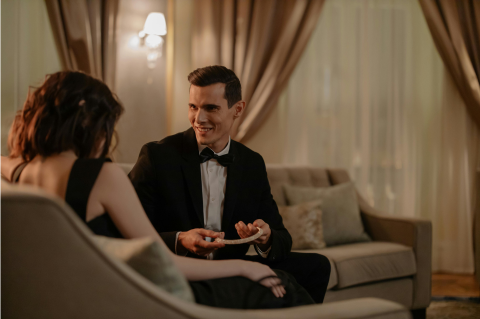 men and woman in room nicely dressed